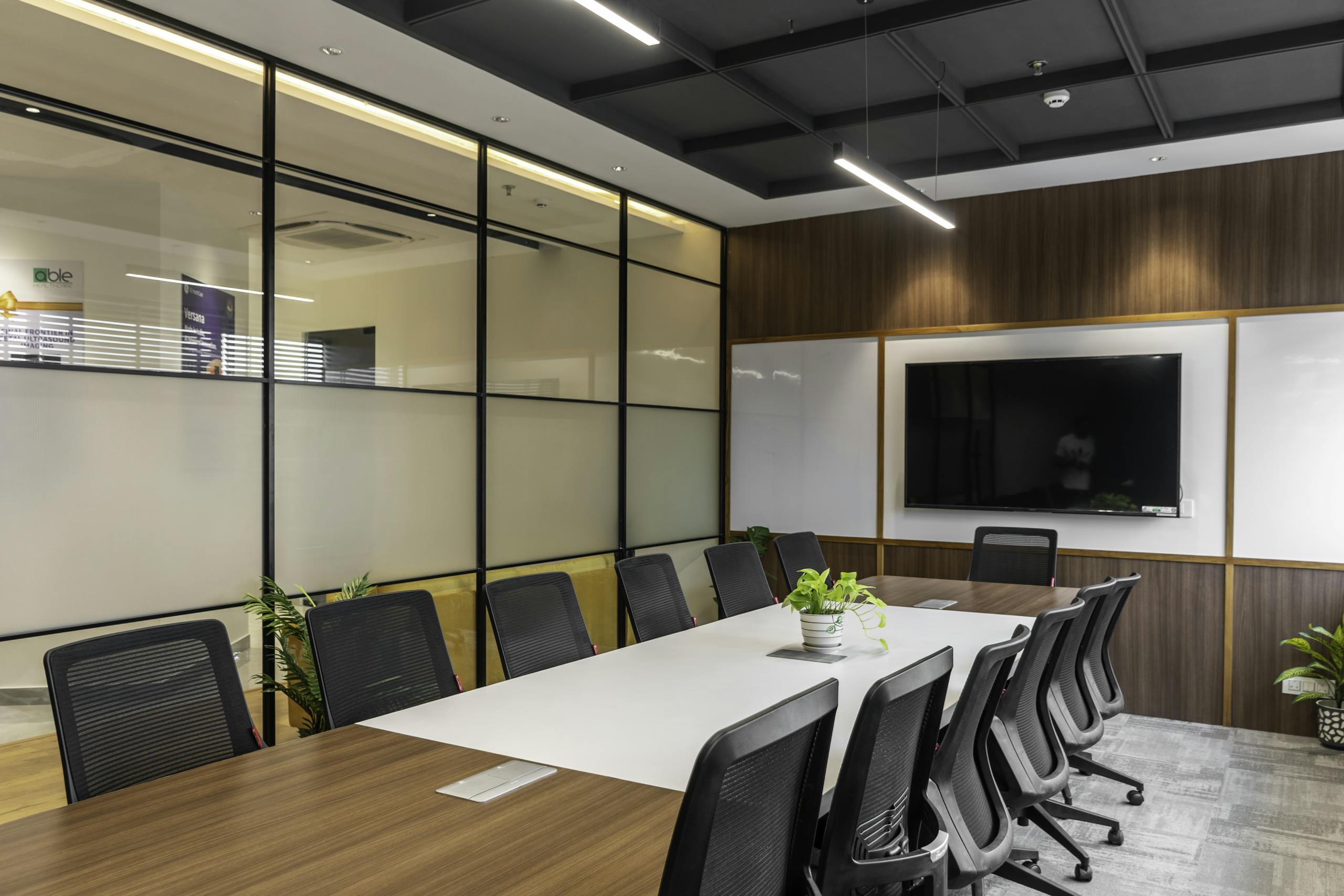 Spacious, stylish office meeting room with large table, chairs, and modern decor in Sahibzada Ajit Singh Nagar, India.