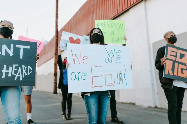 group of people on the street holding placards